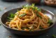 Japchae met knoflook geserveerd, met zoete aardappelnoedels en groenten