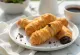 Tulumba met chocolade bedekt, goudbruin gebakken zoetigheid